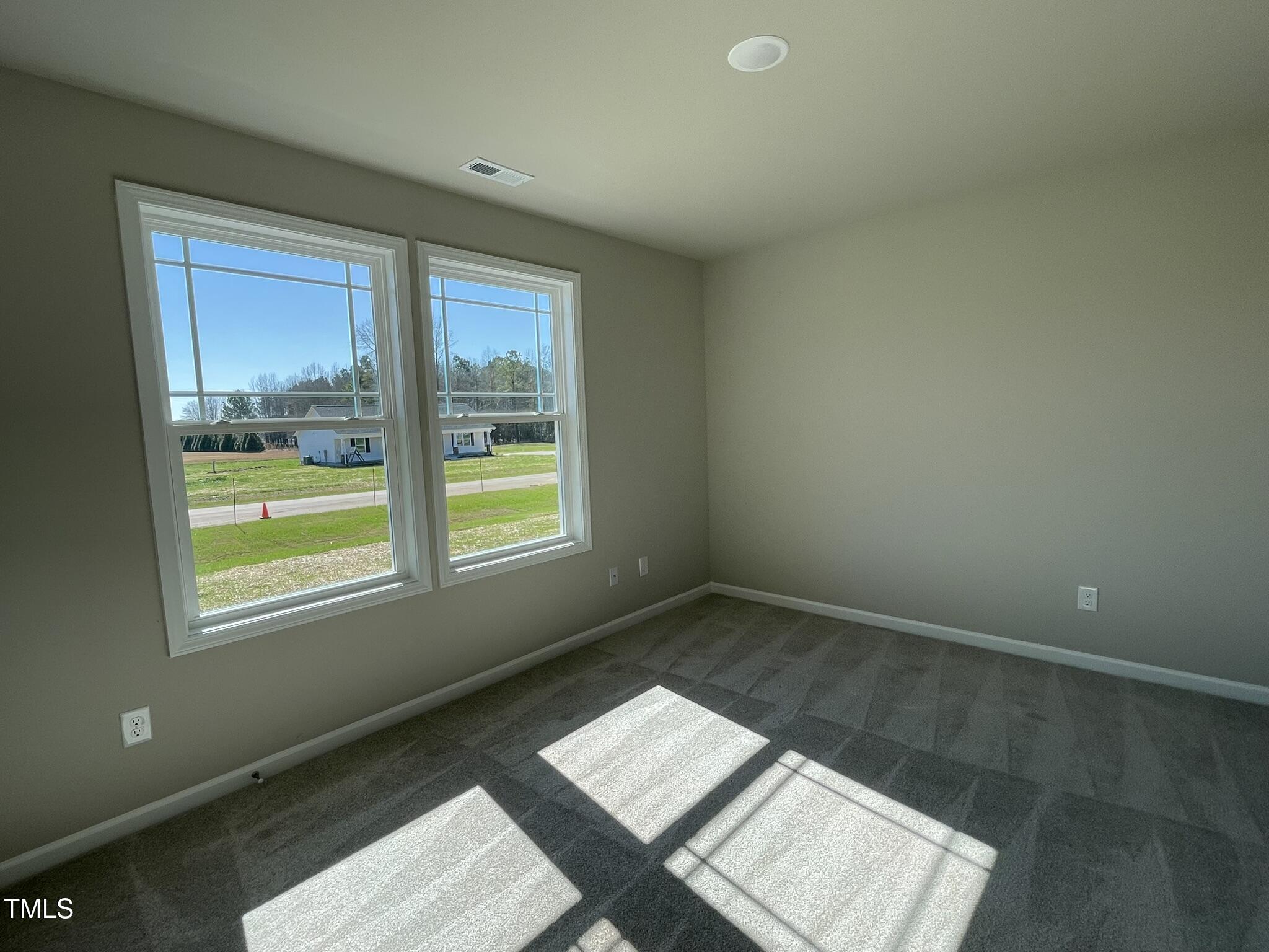 181 Pate Landing Drive Selma, NC 27576 - Photo 10 of 15 a view of wooden floor and windows in a room