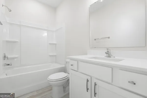 a bathroom with a sink a toilet and a bathtub
