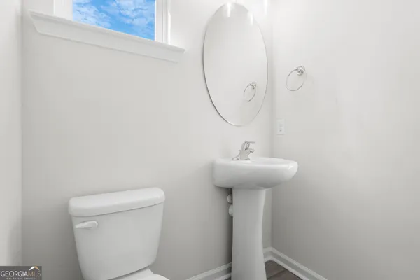 a bathroom with a sink toilet and a mirror