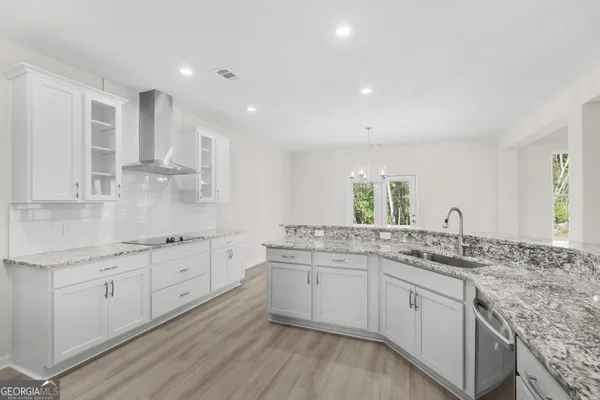 a kitchen with sink stove and cabinets