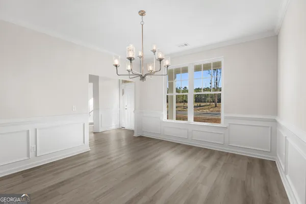a view of wooden floor and windows in a room
