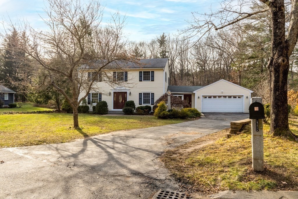a view of a house with snow on the side of the road
