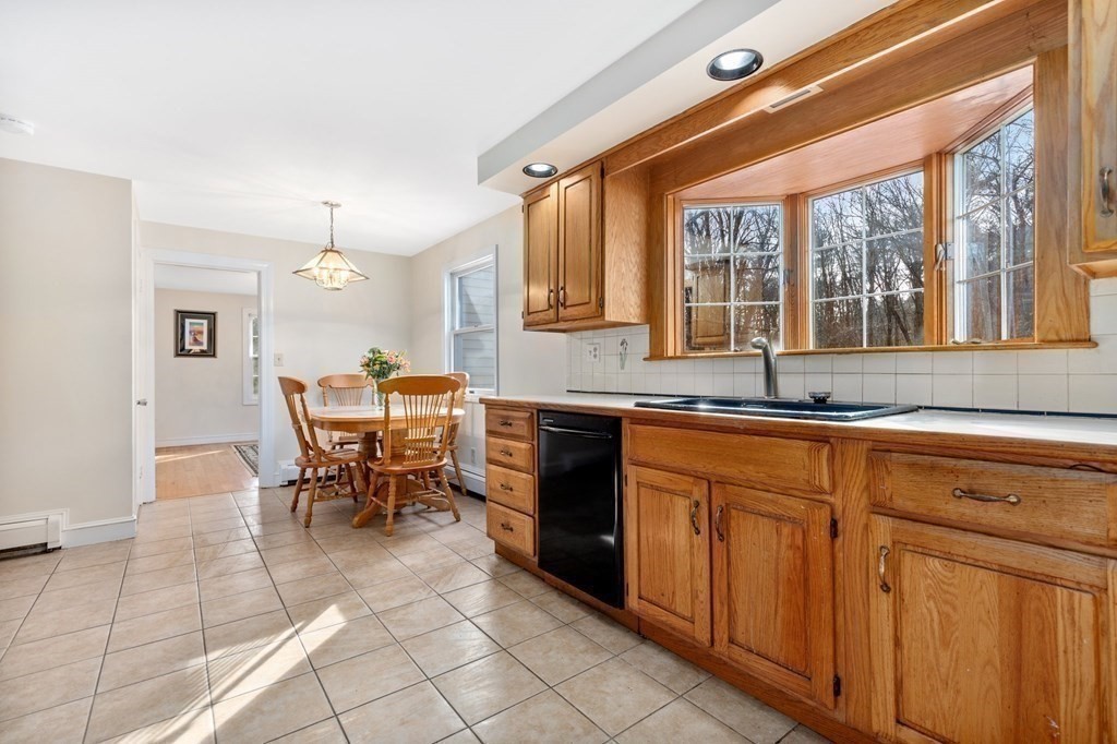 30 Woodside Road Topsfield, MA 01983 - Photo 11 of 42 a kitchen with stainless steel appliances granite countertop a stove a sink and a refrigerator
