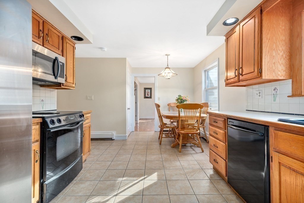 30 Woodside Road Topsfield, MA 01983 - Photo 12 of 42 a kitchen with stainless steel appliances granite countertop a stove top oven a sink and a refrigerator