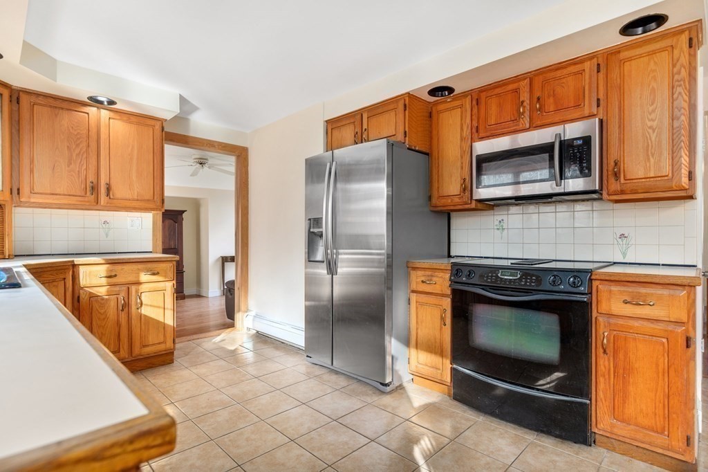 30 Woodside Road Topsfield, MA 01983 - Photo 13 of 42 a kitchen with stainless steel appliances granite countertop a refrigerator and a stove top oven
