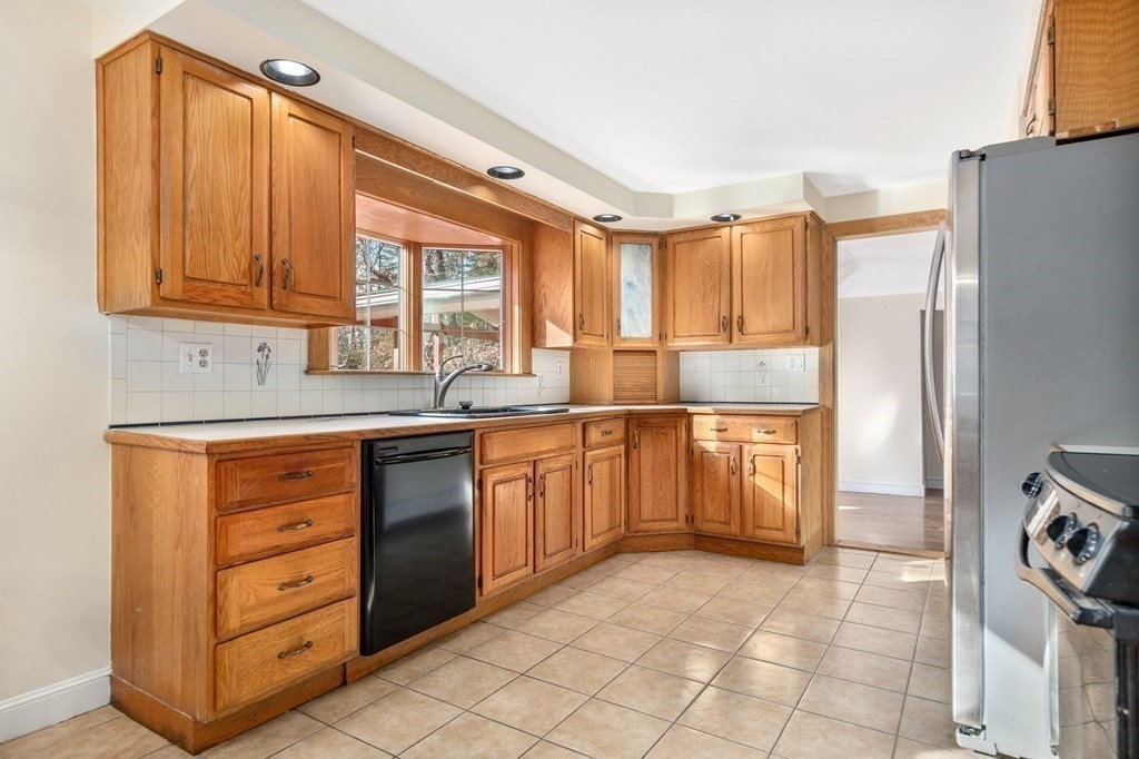 30 Woodside Road Topsfield, MA 01983 - Photo 14 of 42 a kitchen with granite countertop a refrigerator and a sink