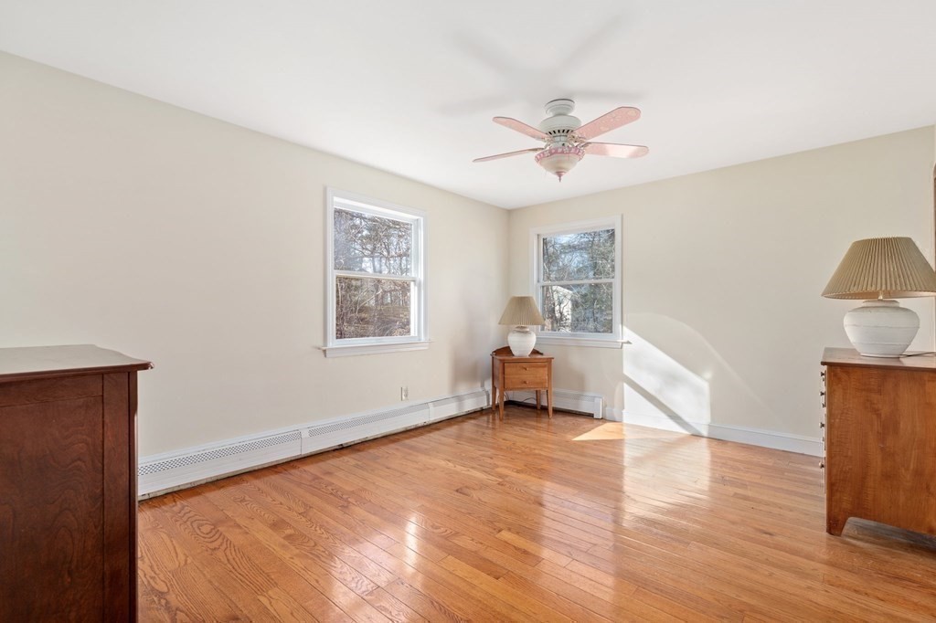 30 Woodside Road Topsfield, MA 01983 - Photo 25 of 42 a view of an empty room with a window and wooden floor