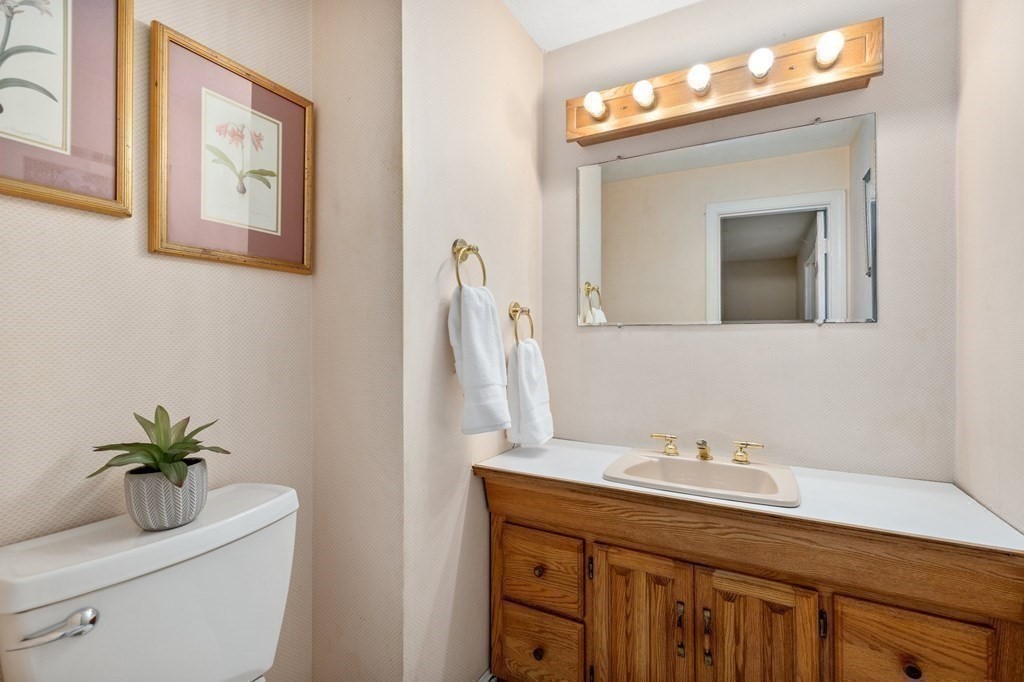 30 Woodside Road Topsfield, MA 01983 - Photo 27 of 42 a bathroom with a toilet a sink and mirror