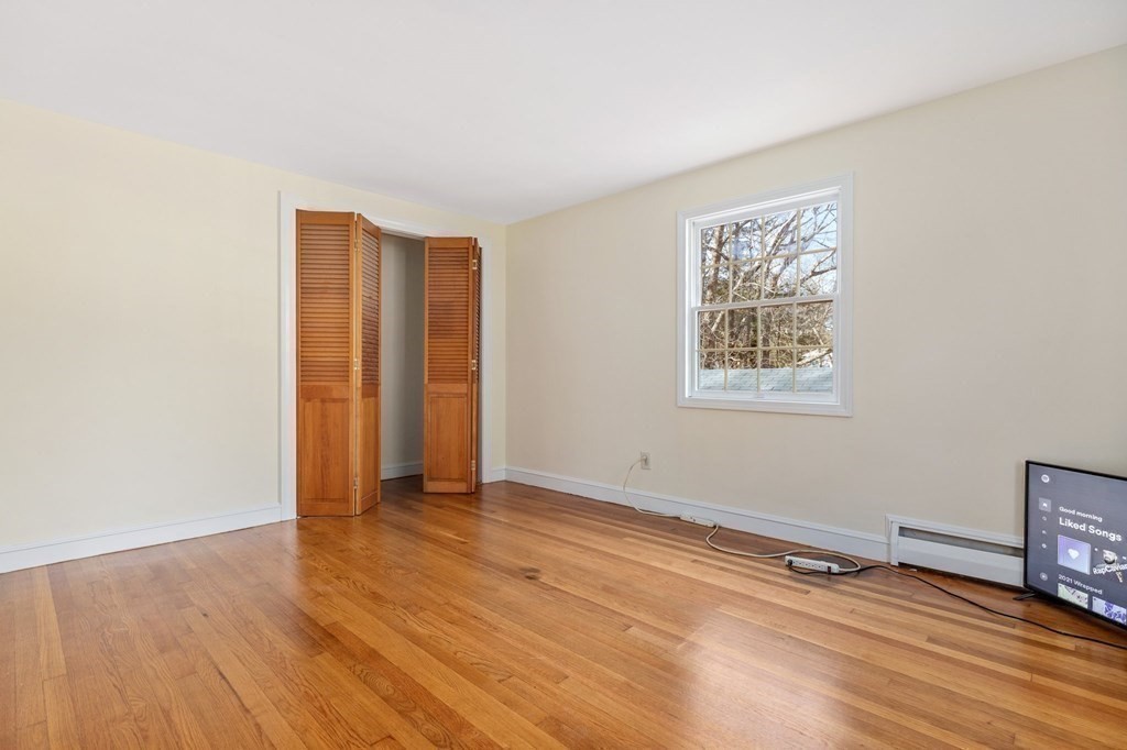 30 Woodside Road Topsfield, MA 01983 - Photo 28 of 42 an empty room with wooden floor and windows