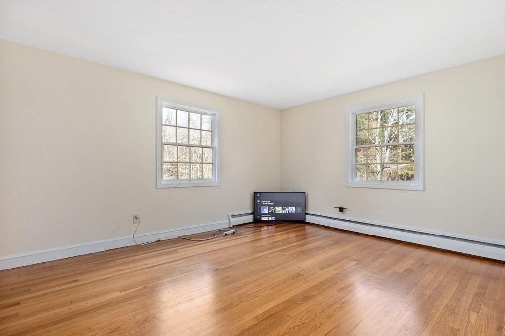 30 Woodside Road Topsfield, MA 01983 - Photo 29 of 42 an empty room with wooden floor and windows