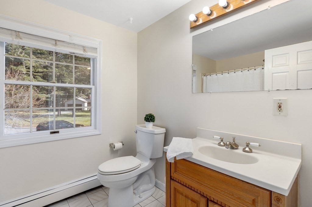 30 Woodside Road Topsfield, MA 01983 - Photo 30 of 42 a bathroom with a sink a toilet and a mirror