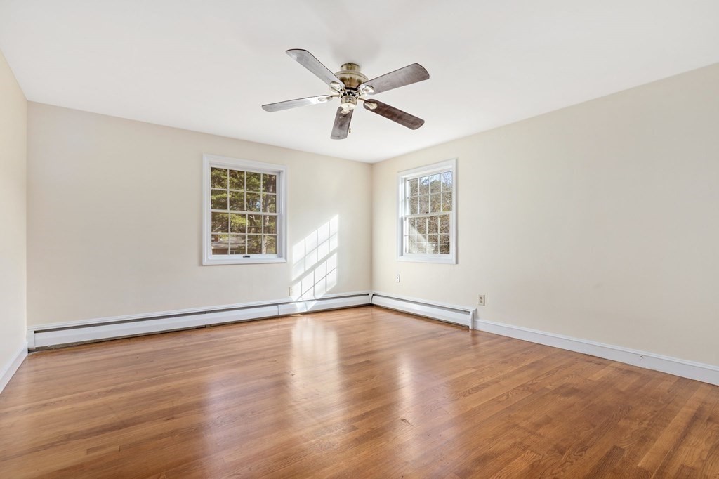 30 Woodside Road Topsfield, MA 01983 - Photo 32 of 42 an empty room with wooden floor window and ceiling fan