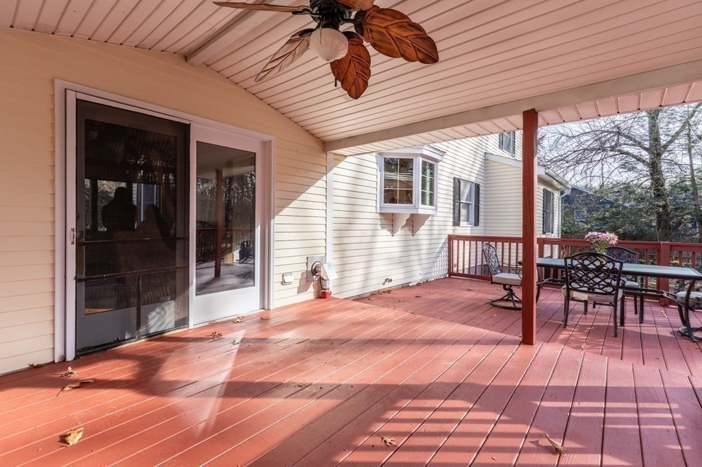 30 Woodside Road Topsfield, MA 01983 - Photo 36 of 42 a view of a patio with table and chairs with wooden floor and fence