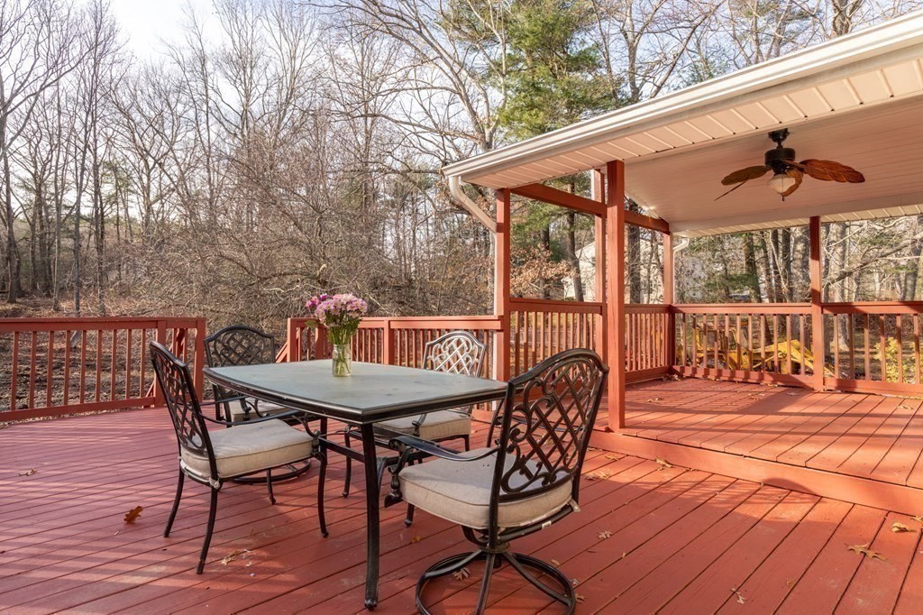 30 Woodside Road Topsfield, MA 01983 - Photo 37 of 42 a patio table and chairs with wooden floor and fence