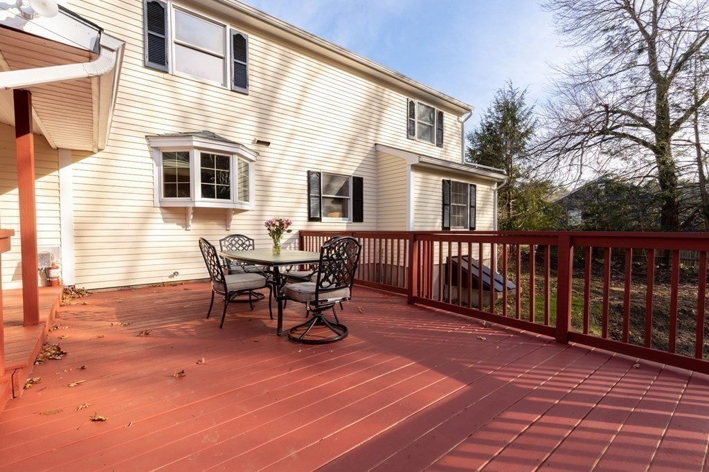 30 Woodside Road Topsfield, MA 01983 - Photo 38 of 42 a view of a roof deck with table and chairs and wooden floor