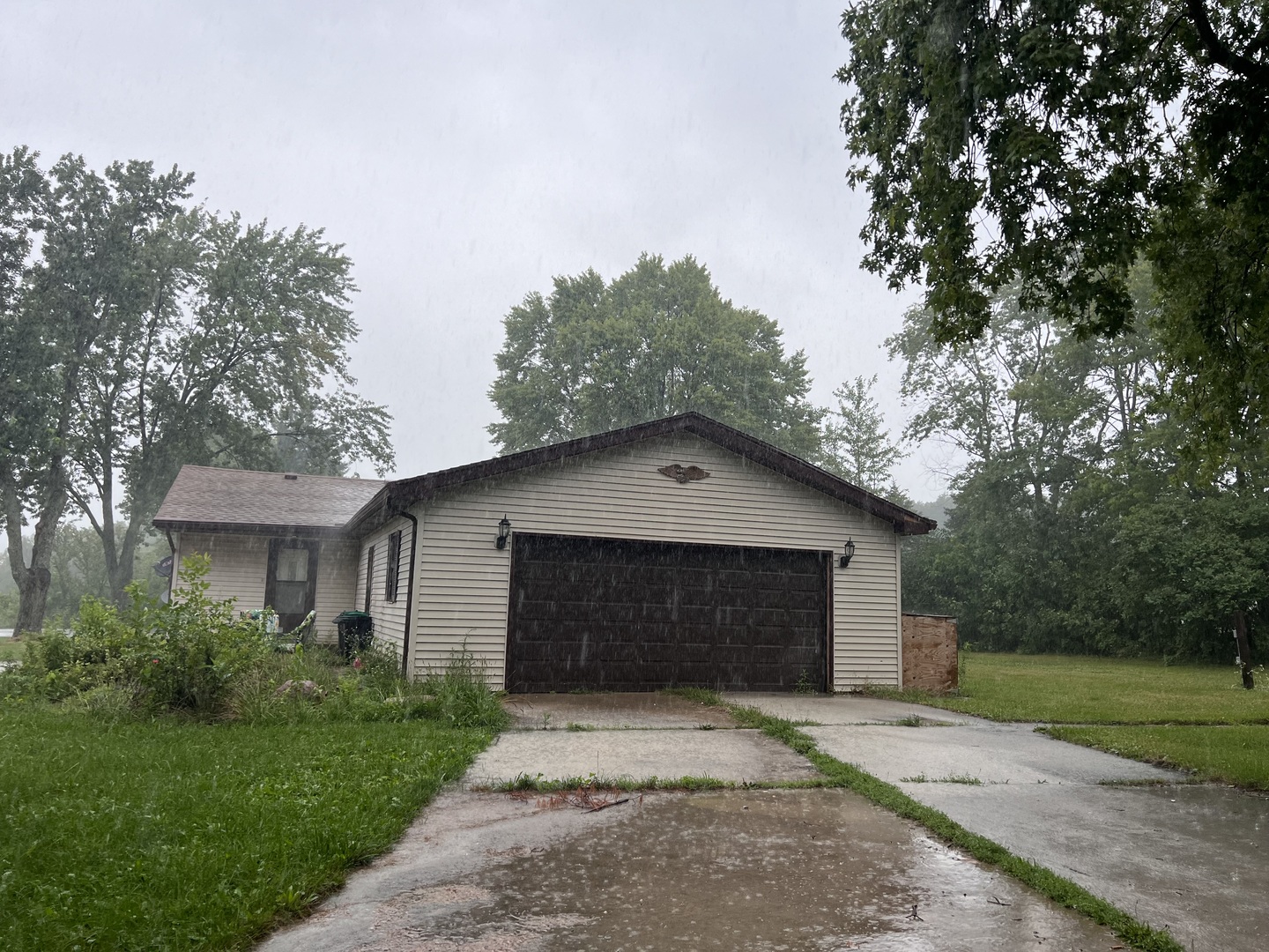 211 Hickory Drive Roberts, IL 60962 - Photo 6 of 14 a front view of a house with a garage and a yard