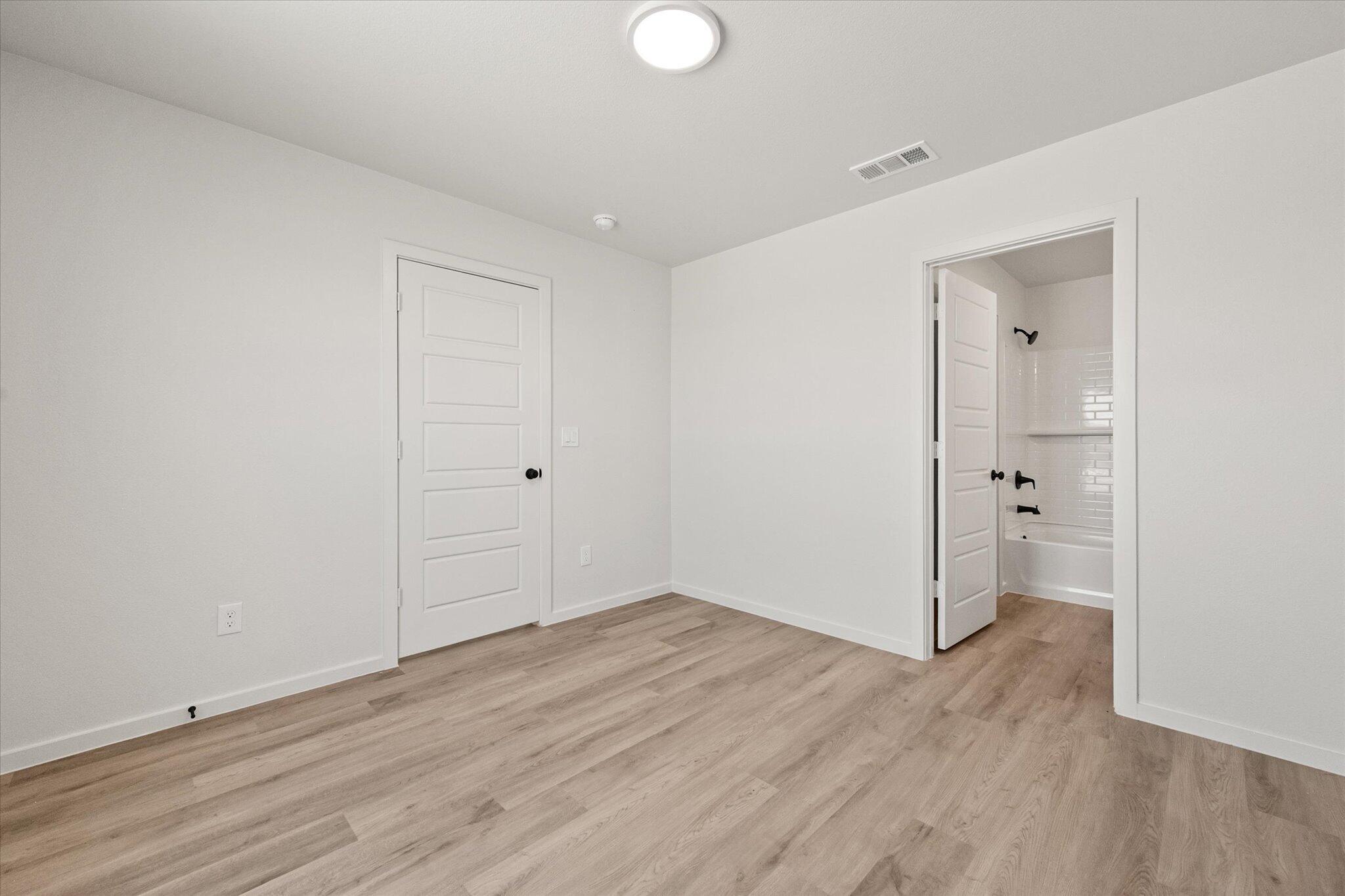 8312 25th Street Lubbock, TX 79407 - Photo 12 of 17 a view of an empty room with wooden floor