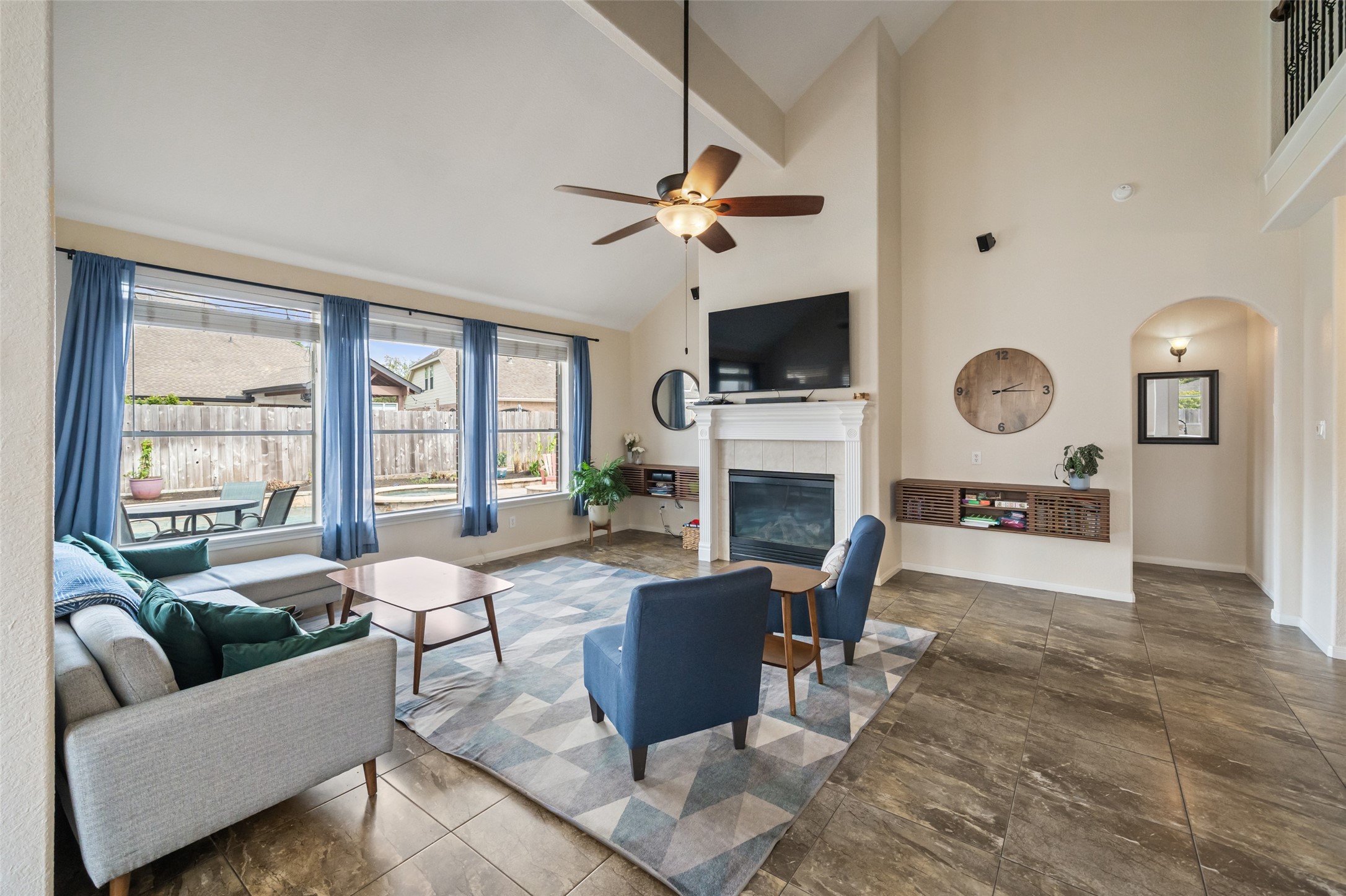 6010 Foxland Court Spring, TX 77379 - Photo 11 of 43 This spacious living room features high ceilings, a cozy fireplace, and large windows that fill the space with natural light.