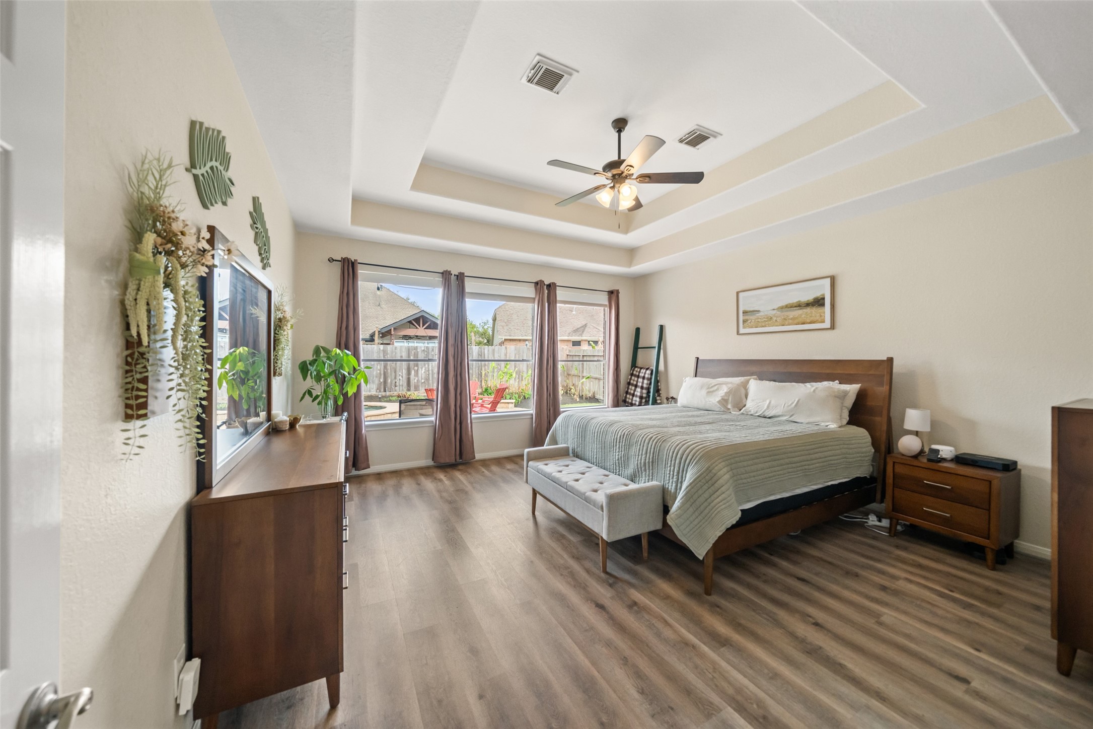 6010 Foxland Court Spring, TX 77379 - Photo 15 of 43 Welcome to the spacious primary bedroom with modern tray ceilings, & large windows that provide lots of natural light.