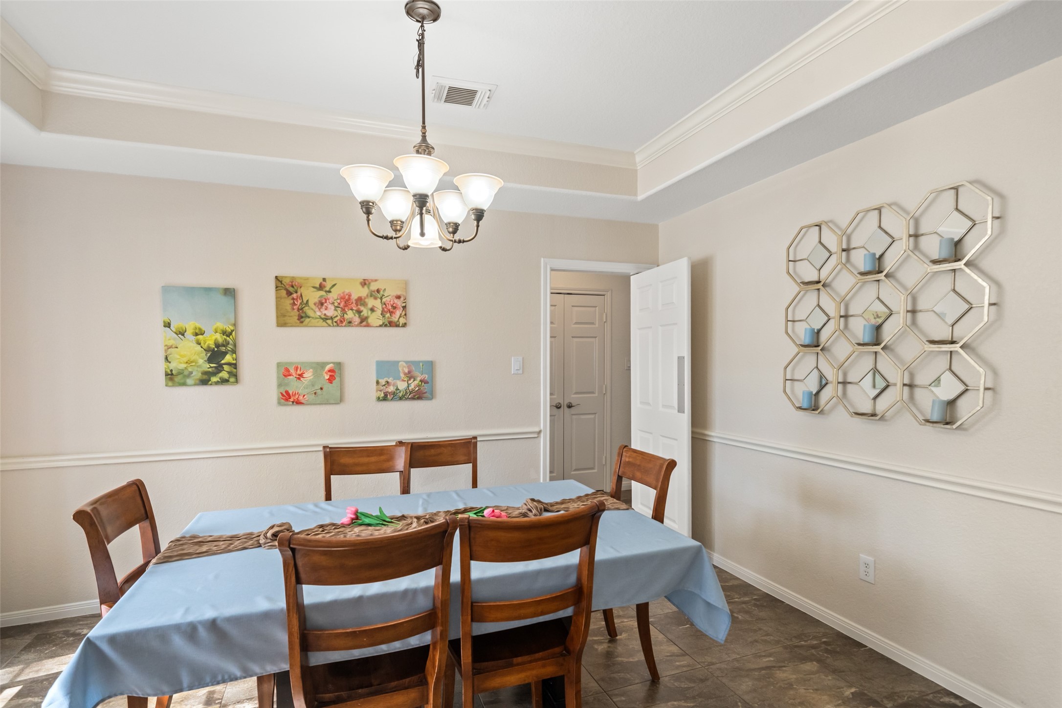 6010 Foxland Court Spring, TX 77379 - Photo 5 of 43 Bright dining room with tray ceiling and an elegant chandelier.