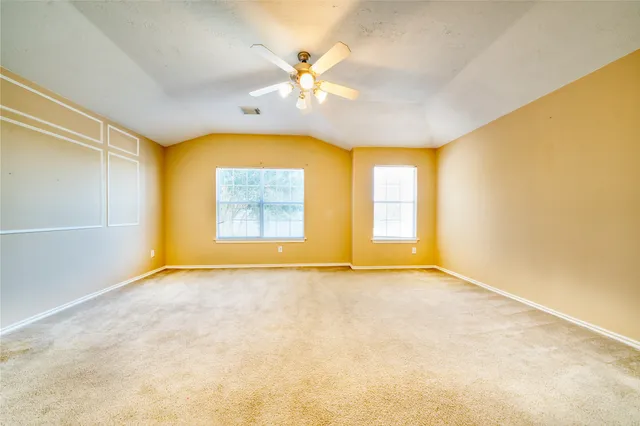 an empty room with windows and closet