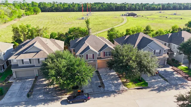 an aerial view of a house with a yard and balcony