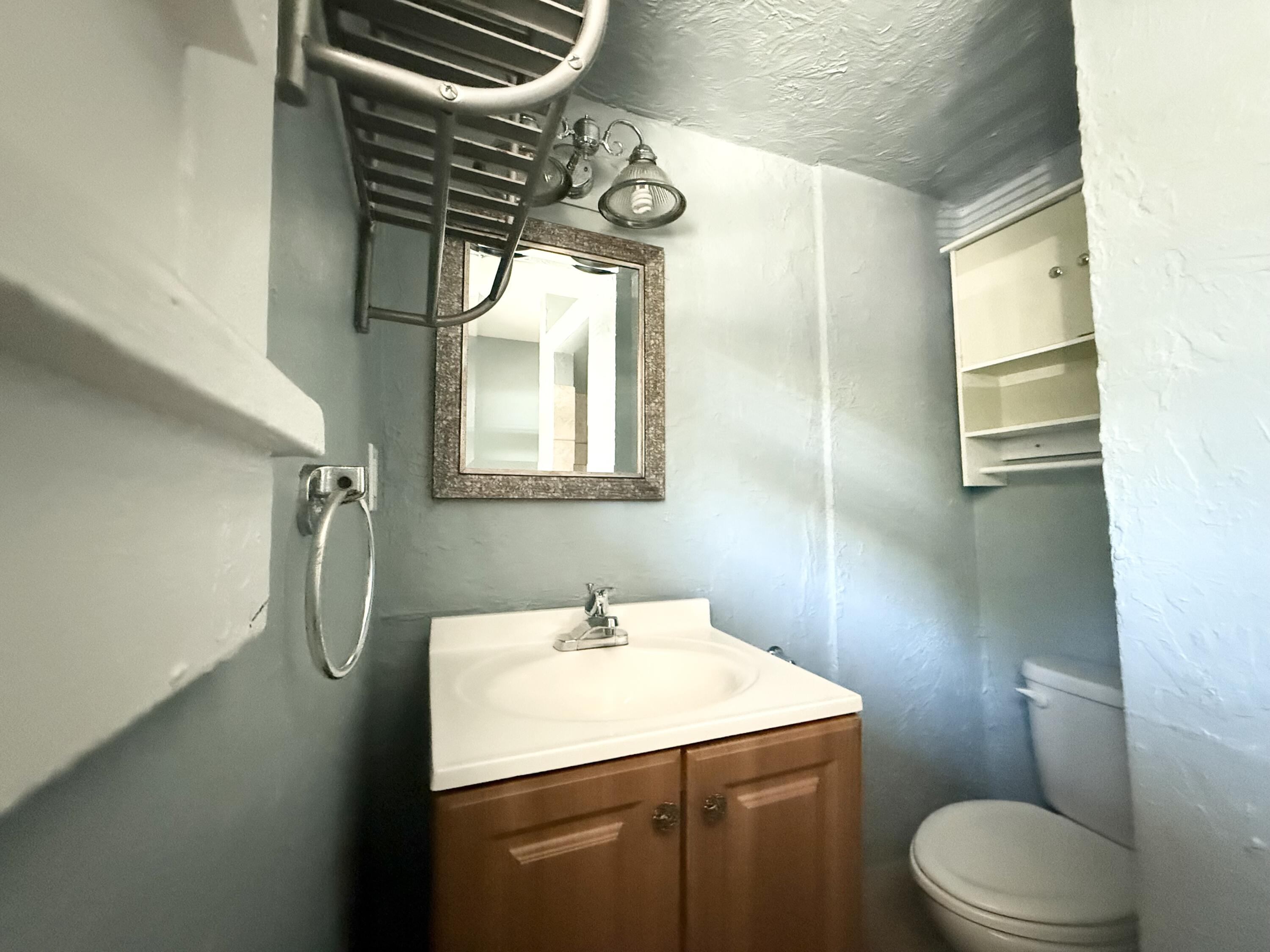 311 Wildermere Road West Palm Beach, FL 33401 - Photo 18 of 27 a bathroom with a sink a toilet and mirror