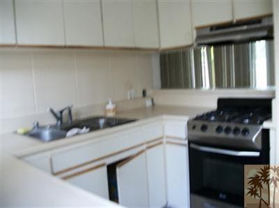 42356 Dunes View Road, Unit 7 Rancho Mirage, CA 92270 - Photo 2 of 9 a kitchen with a sink cabinets and a stove