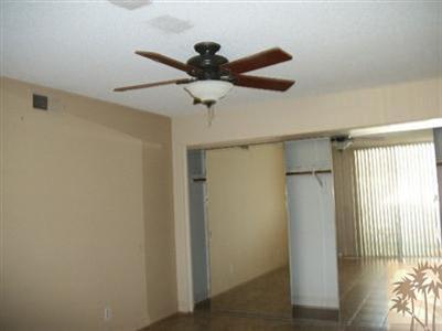 42356 Dunes View Road, Unit 7 Rancho Mirage, CA 92270 - Photo 4 of 9 a view of a room with a ceiling fan and wooden floor