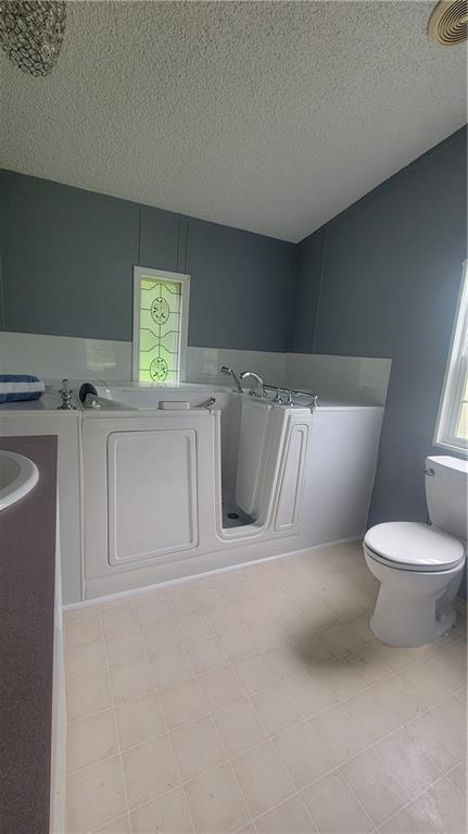 174 Luther Circle Villa Rica, GA 30180 - Photo 19 of 32 a bathroom with a toilet sink and mirror