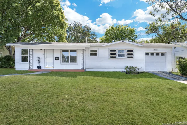 a view of a house with backyard and garden