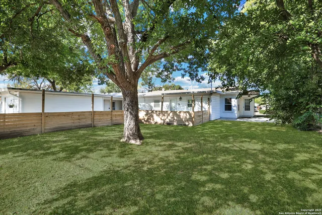 a view of a house with a backyard