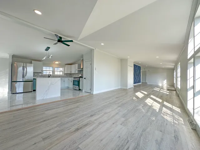 a view of a kitchen with wooden floor and a kitchen