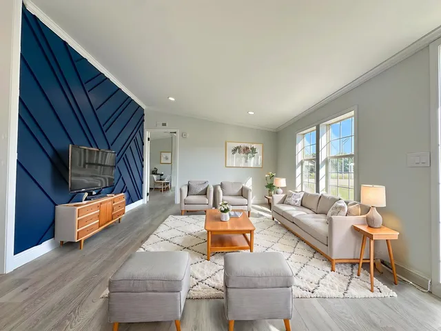 a living room with fireplace furniture and a wooden floor