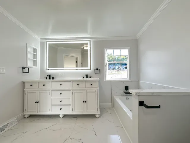 a bathroom with a bathtub sink and mirror