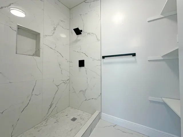 a bathroom with a shower and a shower