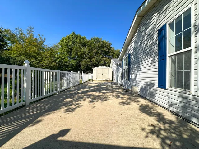a view of a house with a wooden fence