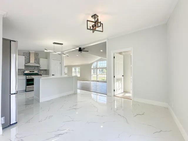 a large kitchen with cabinets and stainless steel appliances