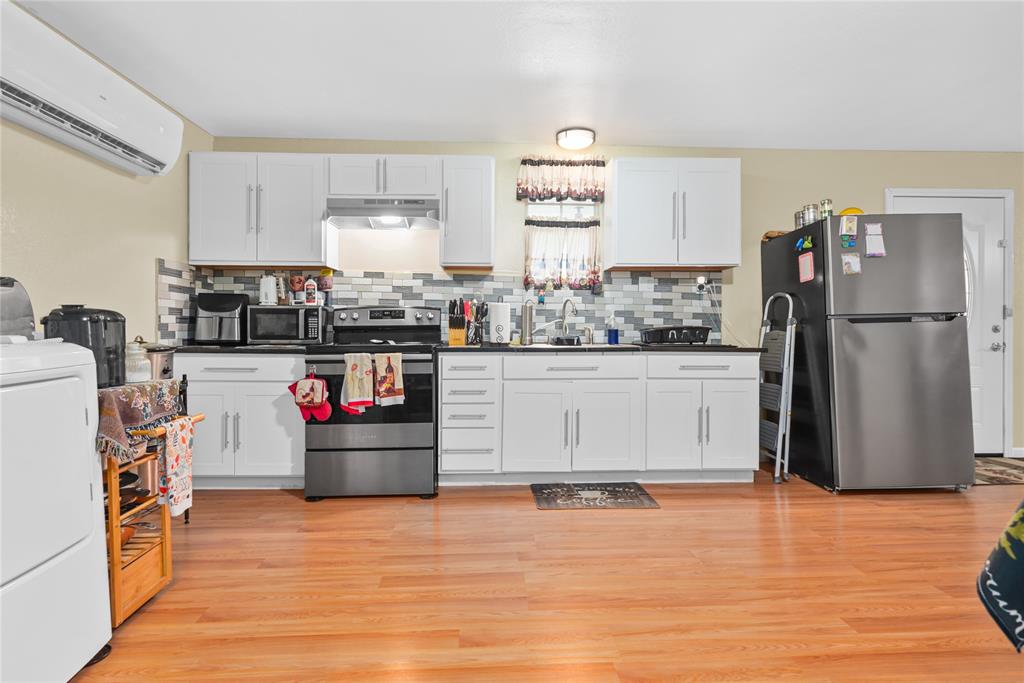 447 Masthead Road Gun Barrel City, TX 75156 - Photo 25 of 27 a kitchen with stainless steel appliances granite countertop a refrigerator and a stove