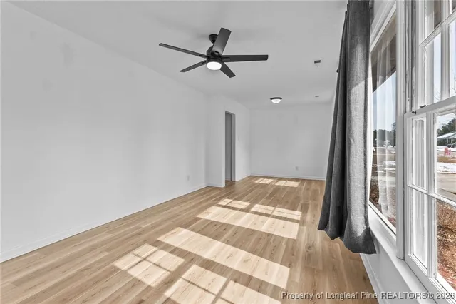 a view of an empty room and wooden floor