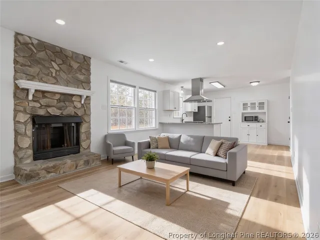 a living room with furniture and a fireplace