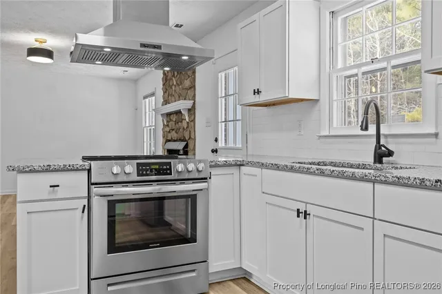 a kitchen with cabinets appliances and a window