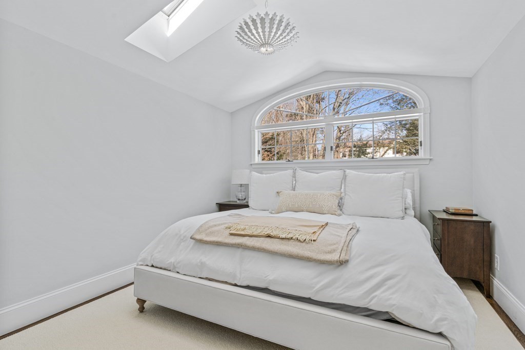 71 Fuller Brook Road Wellesley, MA 02482 - Photo 20 of 24 a bedroom with a bed and a painting on the wall