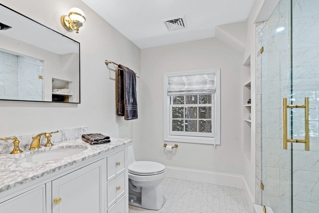 71 Fuller Brook Road Wellesley, MA 02482 - Photo 21 of 24 a bathroom with a granite countertop sink a toilet a mirror and shower