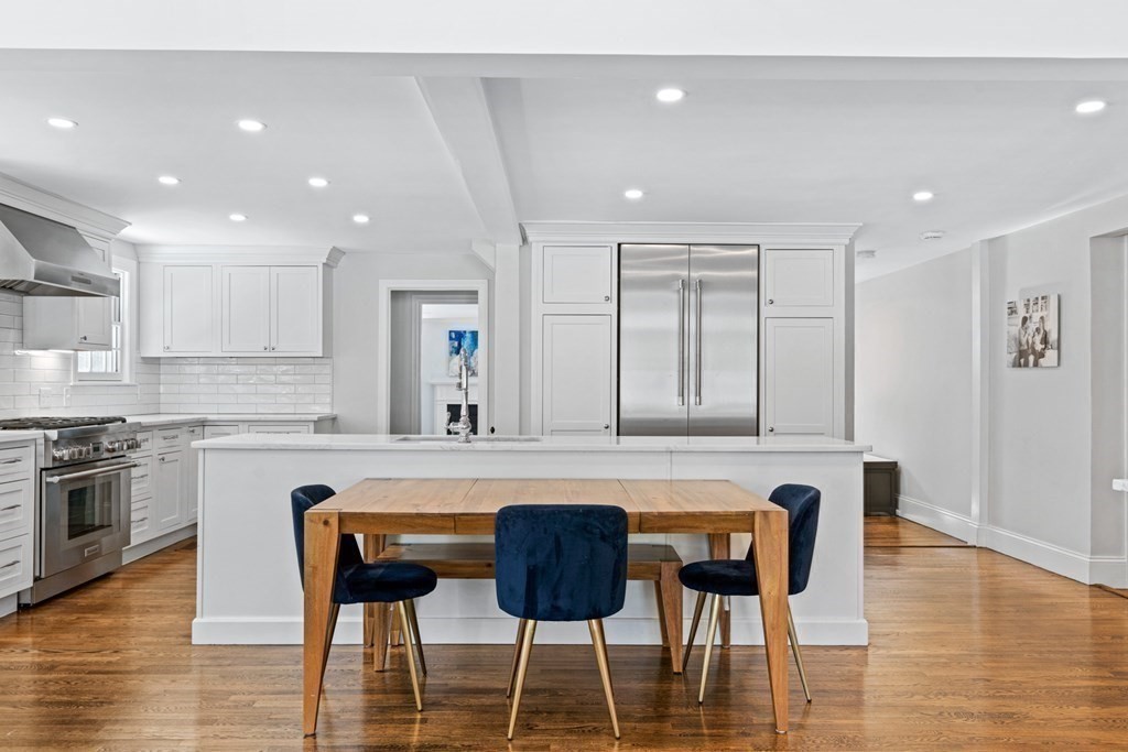 71 Fuller Brook Road Wellesley, MA 02482 - Photo 10 of 24 a kitchen with a table chairs stove and cabinets