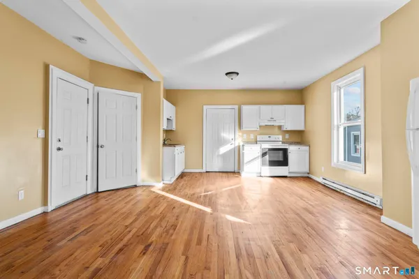 a view of a kitchen with wooden floor and a kitchen