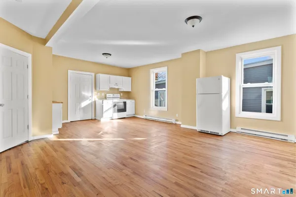 a view of a livingroom with furniture and an empty room