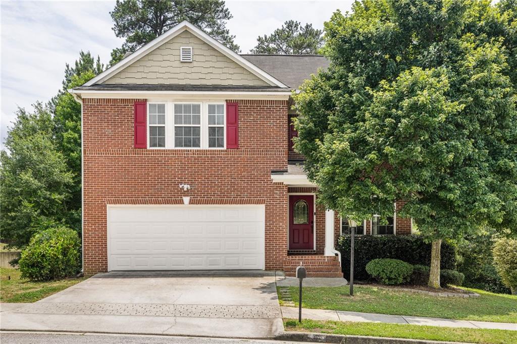 a front view of a house with a yard and garage