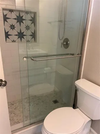 a white toilet and shower