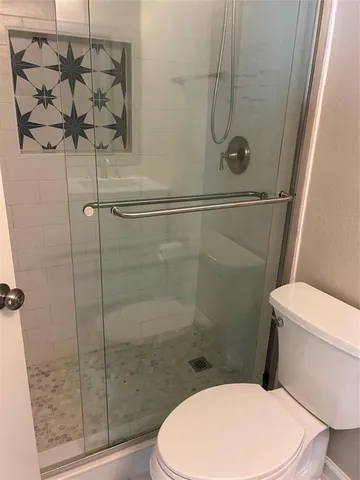 a white toilet and shower